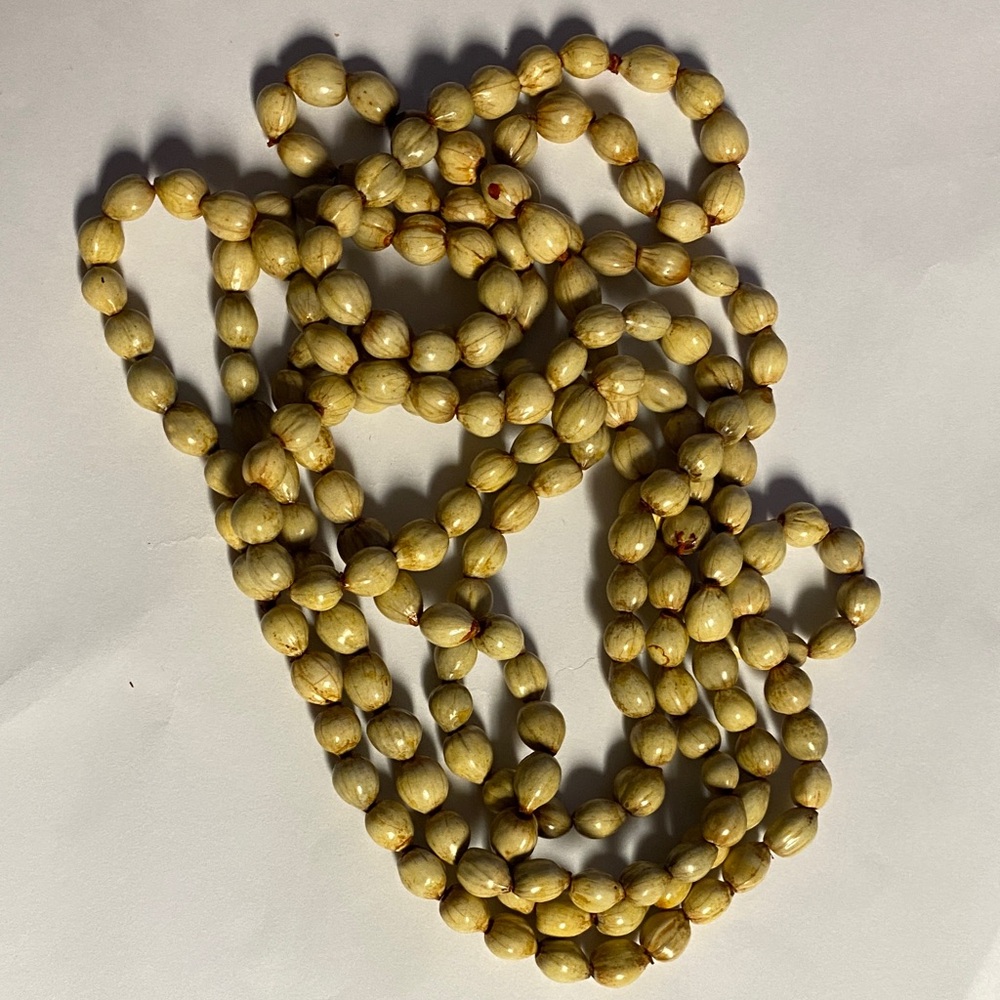 Elegant African Zulu beige seeds, beaded in an extra long necklace.